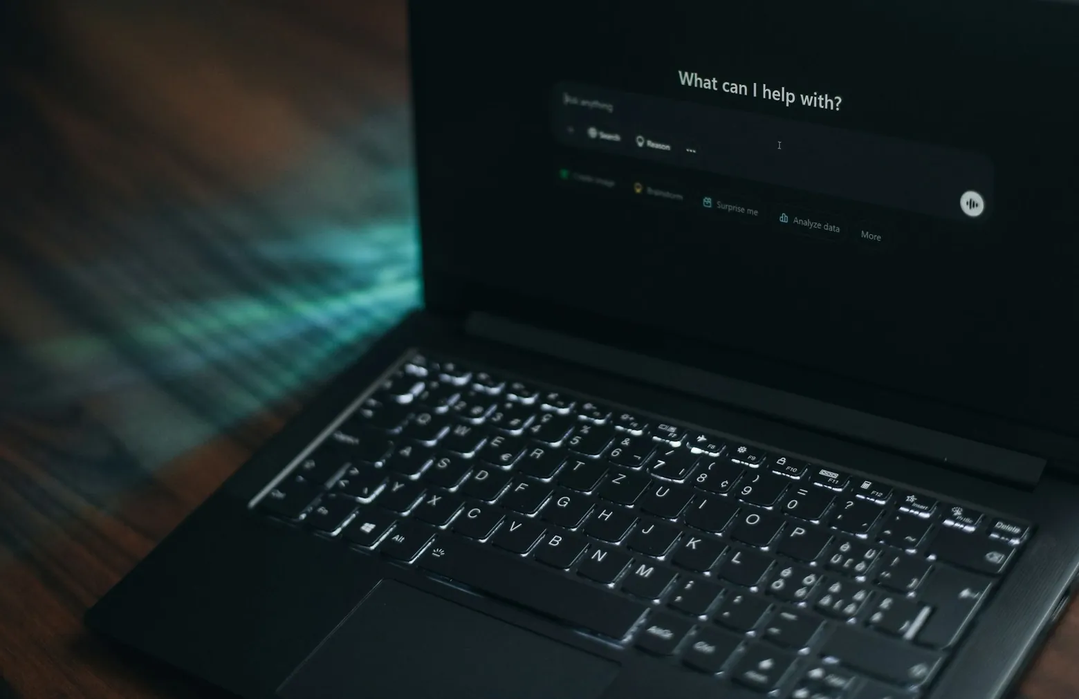 Laptop showing an AI chat window asking what it can help with