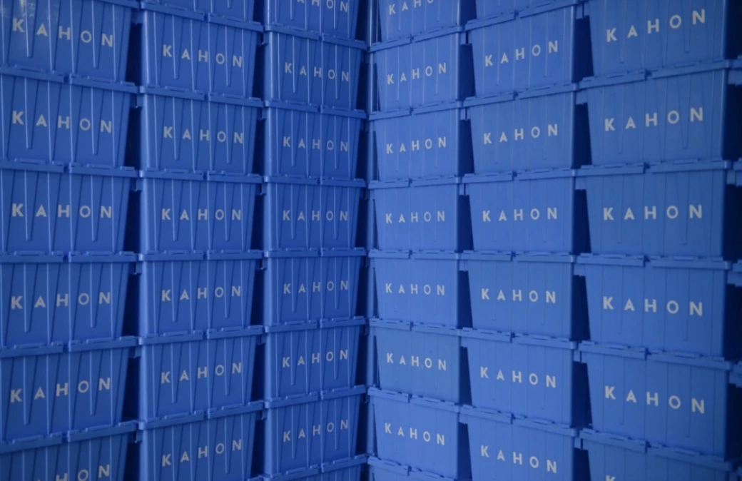 Blue Kahon storage containers stacked in a warehouse